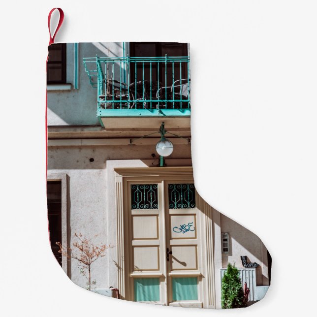 Brown wooden door on white concrete building small christmas stocking (Front)
