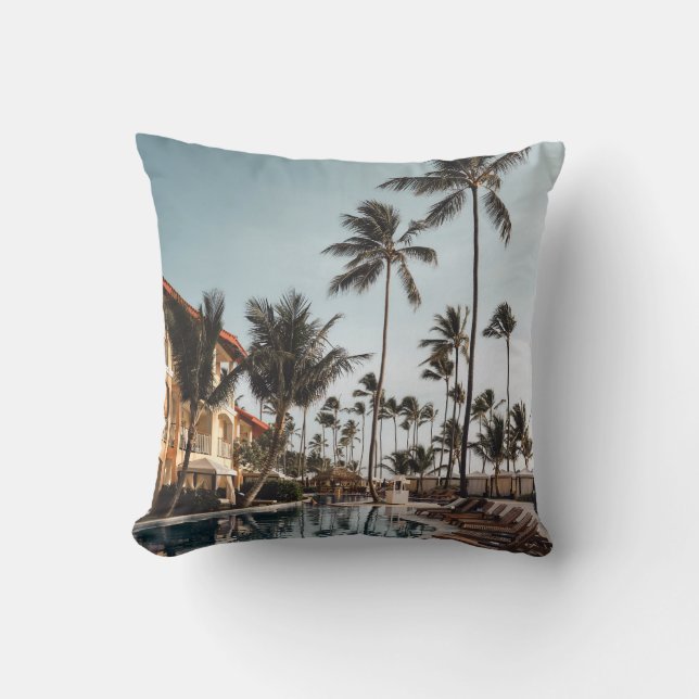 Brown wooden lounge chairs near pool surrounded by throw pillow (Front)