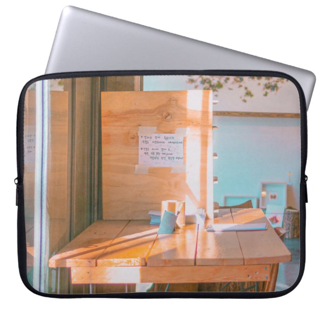 BROWN WOODEN TABLE WITH WHITE PRINTER PAPER LAPTOP SLEEVE (Front)