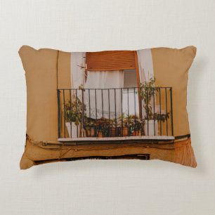 BROWN WOODEN WINDOW FRAME WITH GREEN PLANTS ACCENT PILLOW