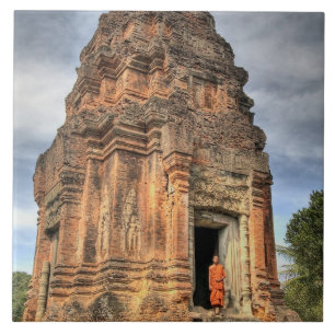 Buddhist monk standing in doorway of temple tile