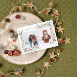 Budget Winter Botanicals & Holly Christmas 2 Photo<br><div class="desc">An elegant & budget Christmas photo card design, featuring two custom photos: one landscape and one portrait, within a chic white frame. The frame is nestled inside the delicate watercolor foliage, creating a naturally organic layout. The foliage includes lush green leaves and bright red berries. There are red poinsettia flowers...</div>