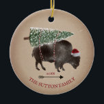 Buffalo Bison Santa Arrow Snow Christmas Tree Ceramic Ornament<br><div class="desc">Illustration of a buffalo wearing a santa hat with a snow covered Christmas tree tied to its back.  Snow speckle and cardstock inspired background with arrow design.</div>