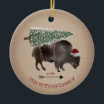 Buffalo Bison Santa Arrow Snow Christmas Tree Ceramic Ornament<br><div class="desc">Illustration of a buffalo wearing a santa hat with a snow covered Christmas tree tied to its back.  Snow speckle and cardstock inspired background with arrow design.</div>
