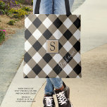 Buffalo Check Plaid Brown Black Monogram Name Tote Bag<br><div class="desc">Black, brown and white buffalo check plaid tote bag personalized with a monogram and optional name shown in a modern, chic handwritten script. The back side is a solid black color that can be changed as desired. The text font style, size and color can also be changed for a different...</div>