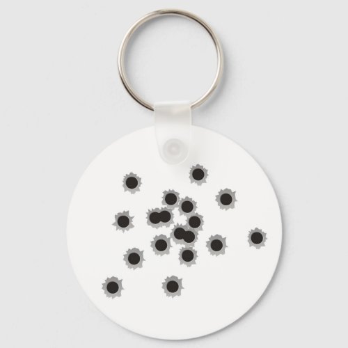 Bullet holes from a rifle or gun possibly shotgun keychain