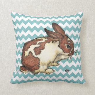 Bunny washing his face with blue chevron throw pillow