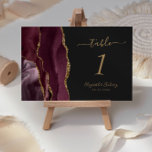 Burgundy Gold Agate Dark Wedding Table Number<br><div class="desc">The left-hand edge of this elegant modern wedding table number card features a burgundy watercolor agate border trimmed with faux gold glitter. The customizable text combines gold colored handwriting,  and italic and copperplate fonts on an off-black background.</div>