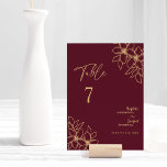 Burgundy Gold Floral Wedding Table Number Card<br><div class="desc">This burgundy gold floral wedding table number card features a gorgeous sophisticated dark merlot backdrop with elegant gold calligraphy and gilded floral embellishments. The jewel-tone color story and the golden botanical boho accents together with minimal delicate script create a regal and romantic modern aesthetic that strikes a perfect balance between...</div>