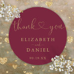 Burgundy Gold Heart Script Thank You Wedding Favor Classic Round Sticker<br><div class="desc">Elegant burgundy and gold heart script thank you sticker personalized with your names and special date. Designed by Thisisnotme©</div>