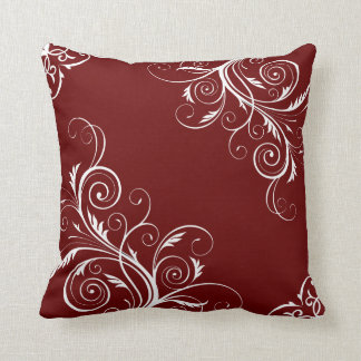 Burgundy pillow with cute patterns.