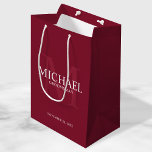 Burgundy Red Personalized Groomsmen Medium Gift Bag<br><div class="desc">Add a personal touch to your wedding with personalized groomsmen gift bag. This gift bag features personalized groomsman's name with title and wedding date in white and monogram in light burgundy red as background, in classic serif font style, on burgundy red background. Also perfect for best man, father of the...</div>