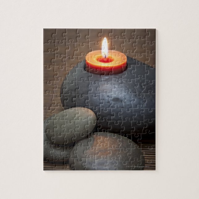 Burning candle flame with rocks in tranquil jigsaw puzzle (Vertical)