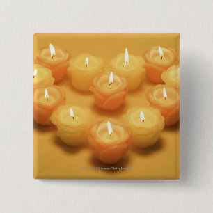Burning candles arranged in a heart shape pinback button