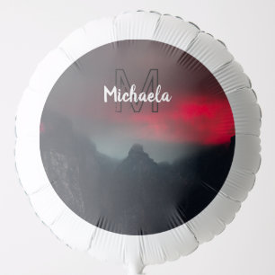 Burning clouds, fog and mountains monogram in sky balloon