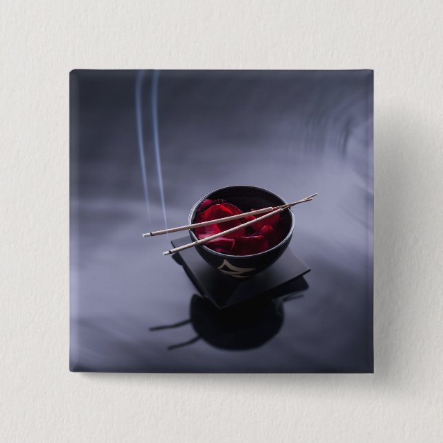 Burning incense on top of bowl of petals button (Front)