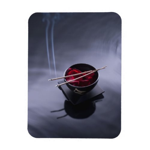 Burning incense on top of bowl of petals magnet
