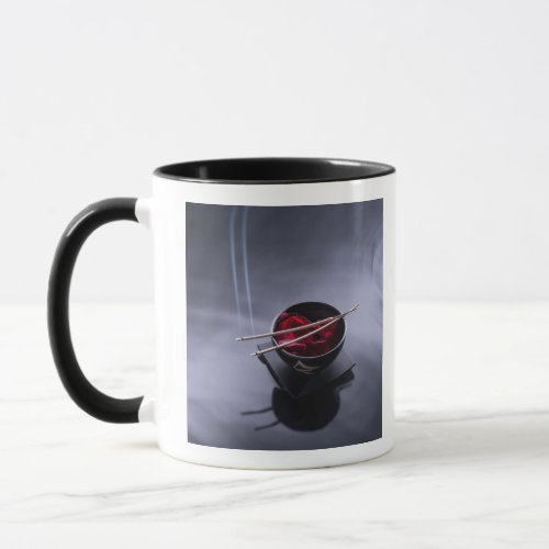 Burning incense on top of bowl of petals mug