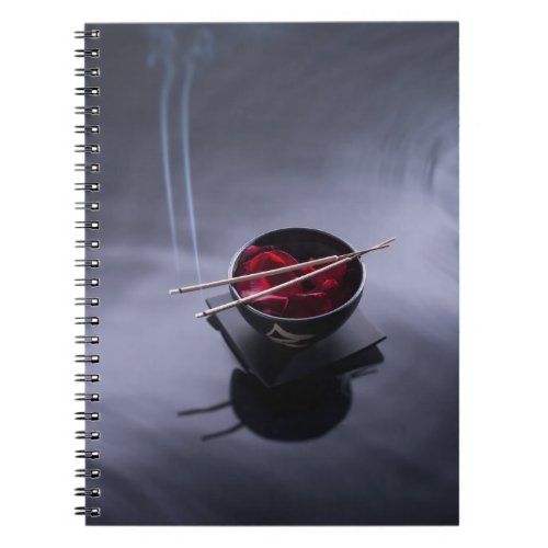Burning incense on top of bowl of petals notebook
