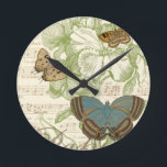Butterflies on Sheet Music with Floral Design Round Clock<br><div class="desc">A green floral design and sheet music serves as the background to a trio of butterflies in this piece by Vision Studio. The French word for butterfly, papillon, is emblazoned at the bottom of the piece as well. If you have a strong love of butterflies, nature, or just like surrounding...</div>