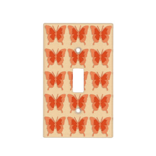 Butterflies, orange on a pastel orange background light switch cover