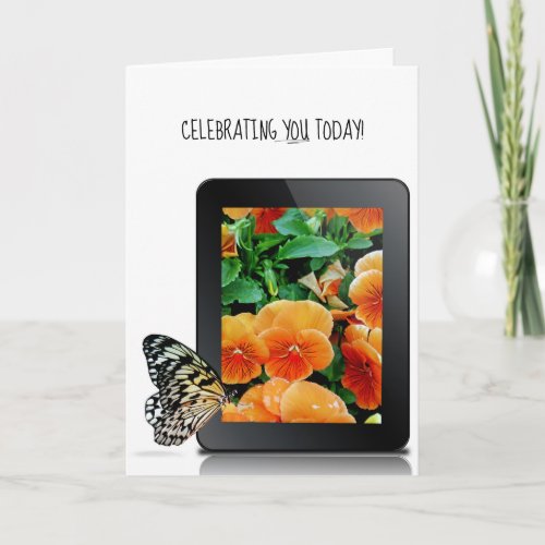 butterfly on electronic tablet device with pansy card