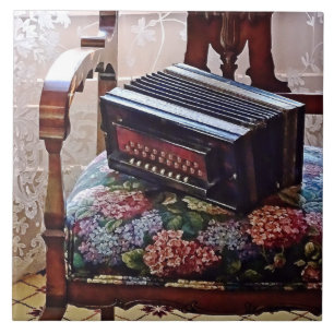 Button Accordion on Chair With Flowered Seat Ceramic Tile