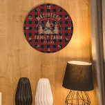 Cabin Family Name Red Buffalo Plaid Large Clock<br><div class="desc">Create a personalized, commemorative round wall clock featuring a rustic red and black buffalo check plaid design and an image of forest pine trees in the woods with your custom text in brown (shown with NAME FAMILY CABIN and year established date). All text is editable. Ideal for a family cabin,...</div>