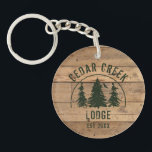 Cabin Rustic Wood Family Name Personalized Keychain<br><div class="desc">Rustic brown wood plank and green forest trees scenic design personalized with your custom text. Ideal for the family cabin or rental lodge and nature retreat properties.  Contact the designer via Zazzle Chat or makeitaboutyoustore@gmail.com if you'd like a design modified or on another product.</div>