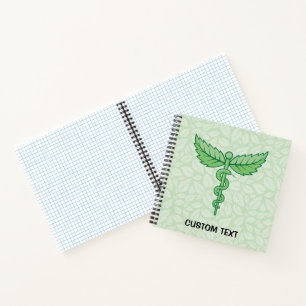 Caduceus with leaves background notebook