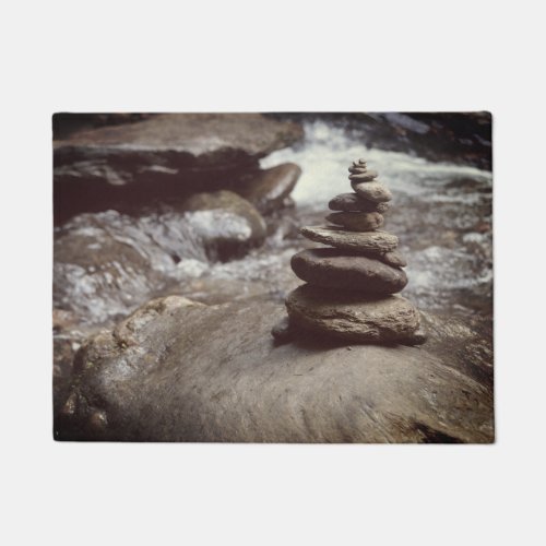 cairn  pile of rocks in a river bed doormat