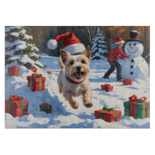 Cairn Terrier Running in Snow with Christmas Hat Cutting Board