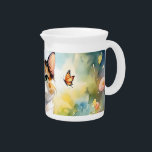 Calico Cat in Spring Garden with Butterflies Beverage Pitcher<br><div class="desc">This enchanting design captures the serene beauty of a calico cat nestled among blooming spring flowers, with delicate monarch butterflies fluttering nearby. The soft watercolor style brings a dreamlike atmosphere to the scene, blending gentle pastels and vivid floral tones to create a magical, storybook setting. The cat’s expressive green eyes...</div>