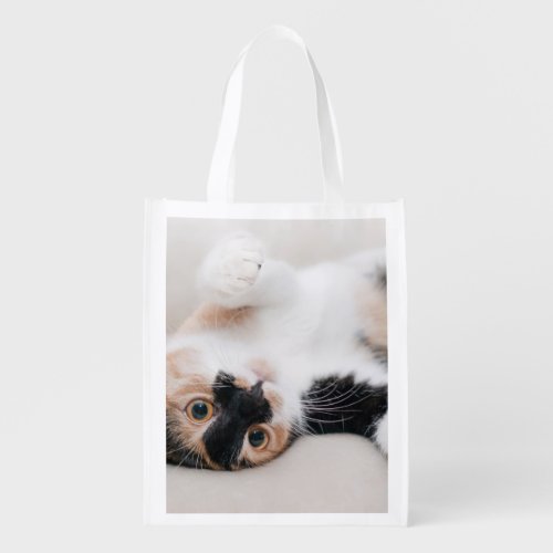 Calico Cat Laying on his back with paws up Grocery Bag