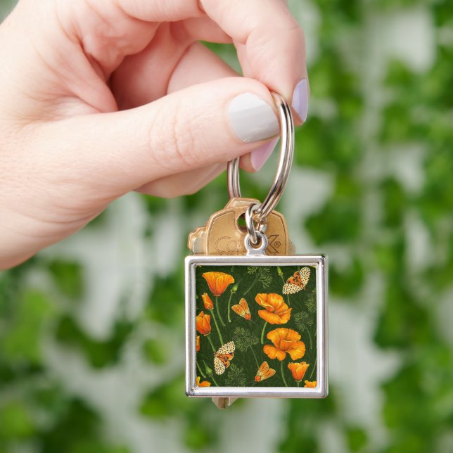 California poppies and moths on dark green keychain (Hand)