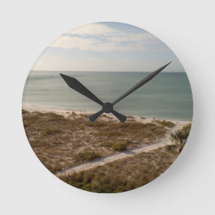 Calm Gulf Shoreline With Blue Sky Horizon Round Clock