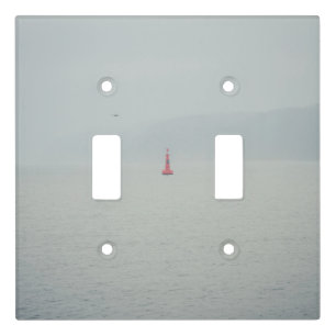 Calm winter sea and red lighthouse light switch cover