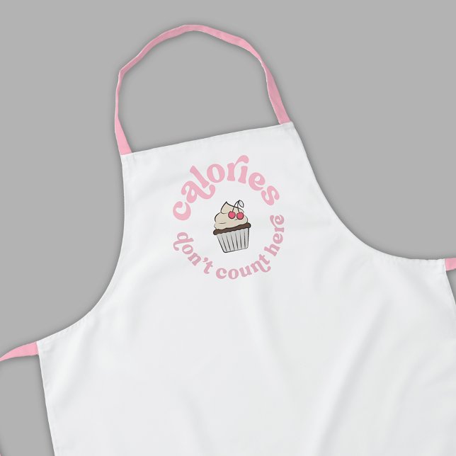 Calories Don't Count Here Pink Cake Baker Funny Apron (Modern white and pink cupcake apron design with retro font that reads 'Calories Don't Count Here')