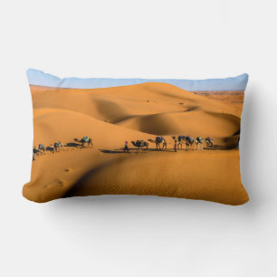 camels on desert under blue sky lumbar pillow
