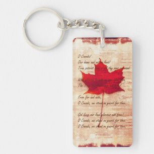 Canadian anthem on grunge background with red mapl keychain