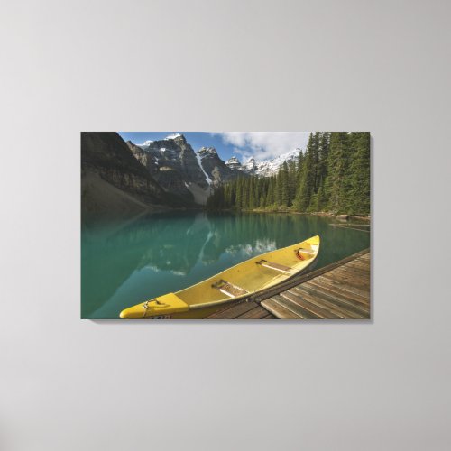Canoe parked at a dock along Moraine Lake Banff Canvas Print