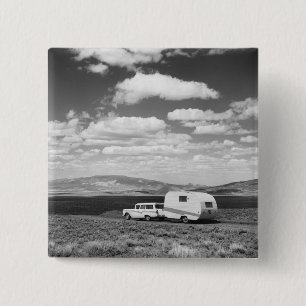 Car pulling trailer on road pinback button