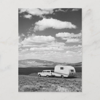 Car pulling trailer on road postcard