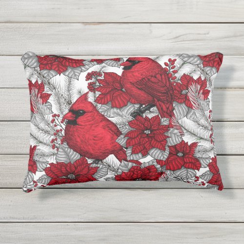 Cardinals and poinsettia in red and white outdoor pillow