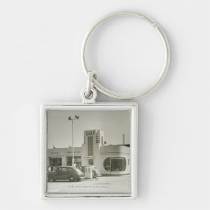Cars parked at gas station keychain