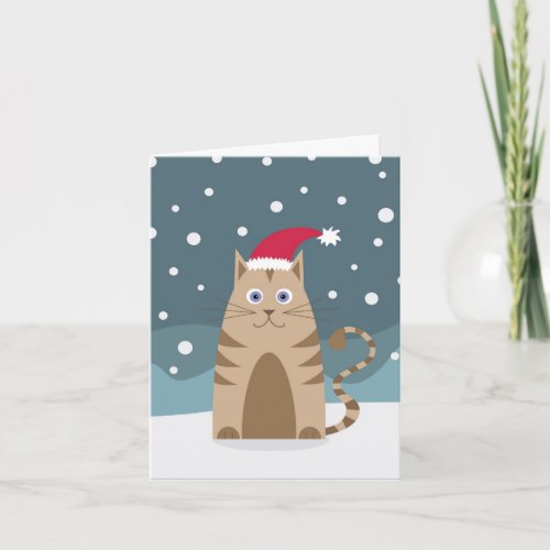 Cartoon pet cat wearing santa hat in snow card