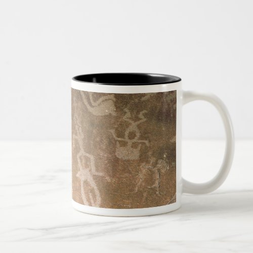 Carved petroglyph depicting figures Two_Tone coffee mug