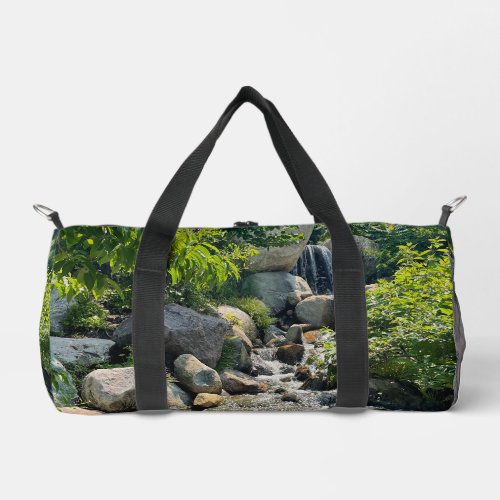 Cascading forest waterfall  forest greenery   duffle bag