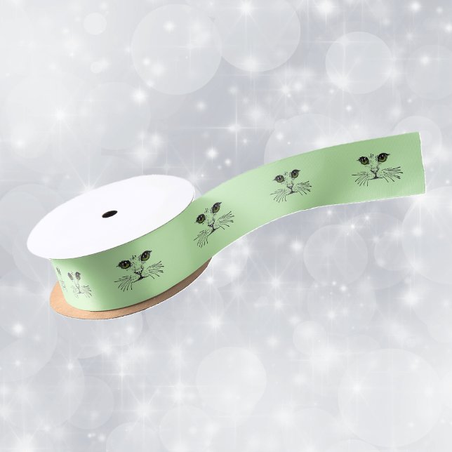 Cat Face Green Eyes Whiskers Satin Ribbon (black illustration of the face of a cat long whiskers green eyes on roll of green gift wrap ribbon.)