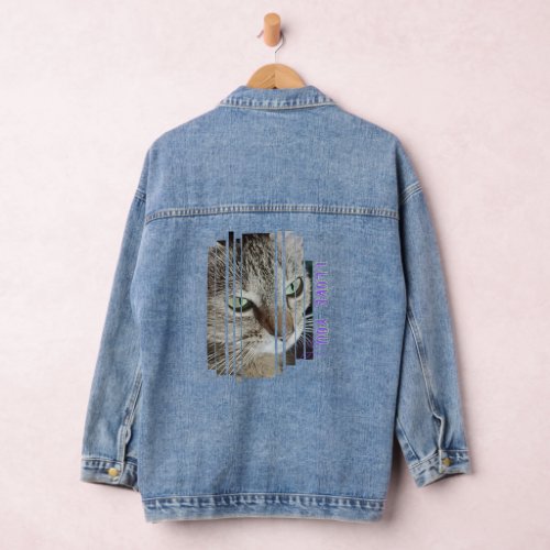 Cat gazes lovingly at its owner denim jacket